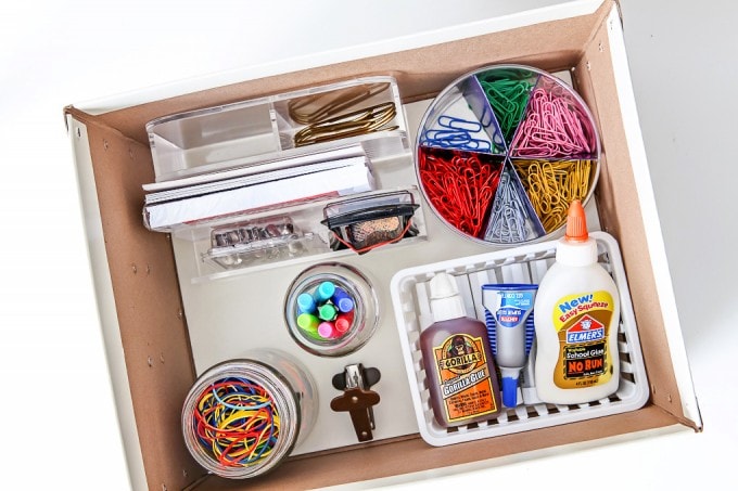 Office supplies organized with bins within a larger bin